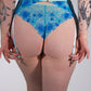 Person wearing blue floral lace underwear against a white background