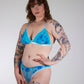 Woman wearing a blue lingerie with a white background