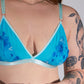 Person wearing a blue floral lingerie set against a plain background