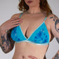Woman wearing a blue floral lingerie against a plain background