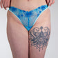Person wearing blue lace underwear with a white background
