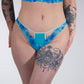 Person wearing blue lace underwear with a white background
